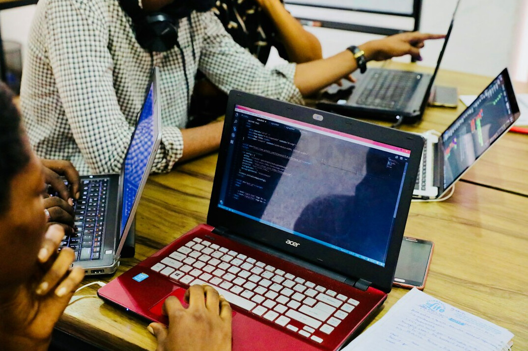 group of students coding together