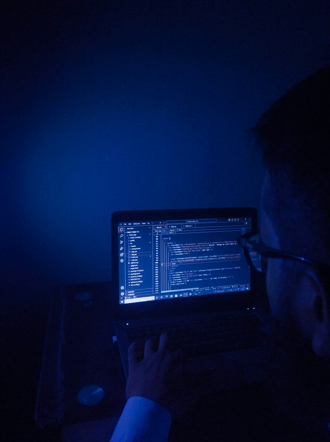 person coding on laptop