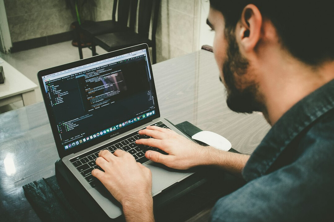 programmer working on laptop